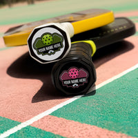 Personalized pickleball paddle tags on paddles on a pickleball court