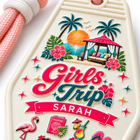Close-up of UV printed Girls Trip artwork with palm trees, sunset, hibiscus flowers and the name Sarah on a motel keychain