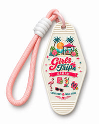Cream retro motel keychain with Girls Trip tropical artwork personalized with the name Sarah and a pink paracord strap