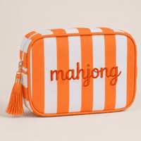 Orange and white striped Mahjong tile bag with an orange tassel and embroidered mahjong lettering